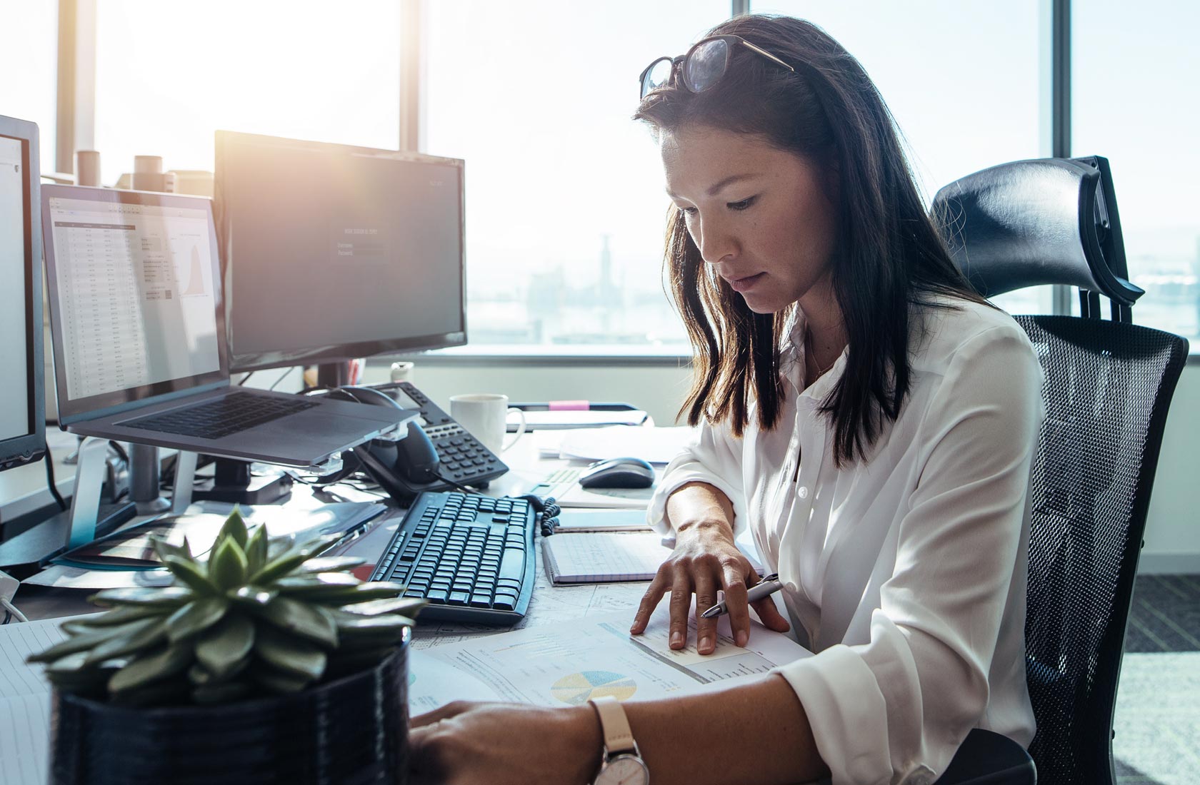 Woman works at a desk in a modern office building