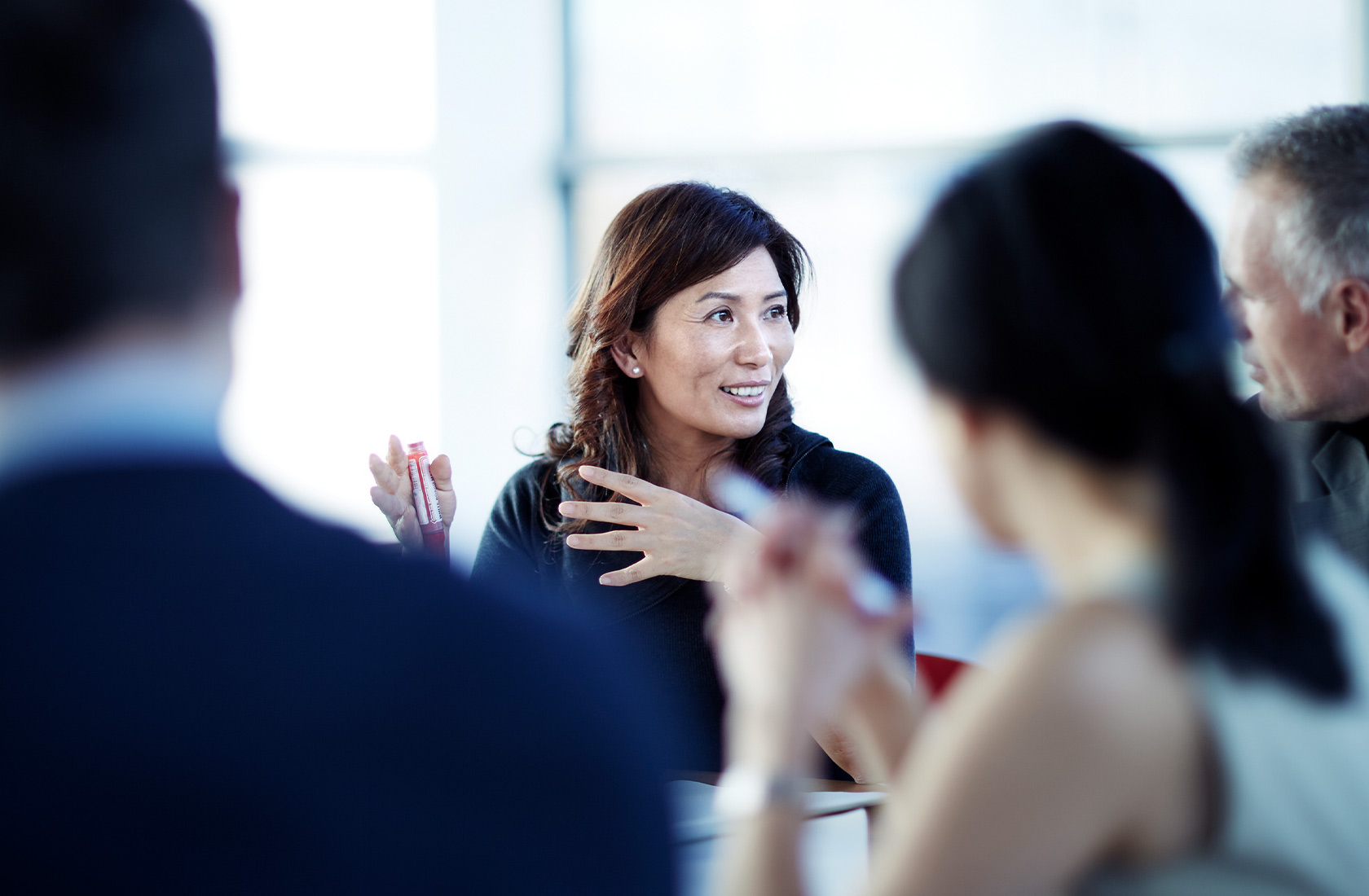 Business woman in meeting with colleagues in a contemporary office