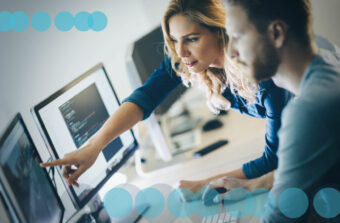 A man and a woman work together on a computer programming project. Depicting how increasing the value of KYC data with digital profiles is a positive.